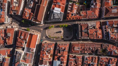 overhead aerial hyperlapse of people and cars on a square in lisbon city center
