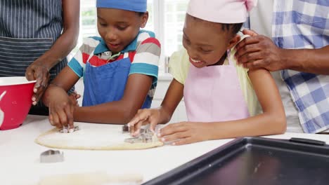 happy family preparing cookies in kitchen