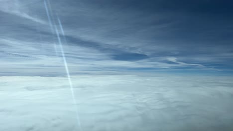 a pilot’s perspective: flying over a blanket of clouds in a splendid winter day