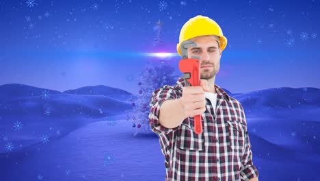 Animation-of-snow-falling-over-caucasian-male-mechanic-and-christmas-landscape