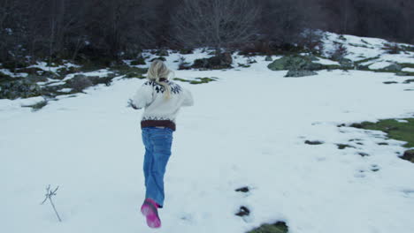 girl running in snowy landscape