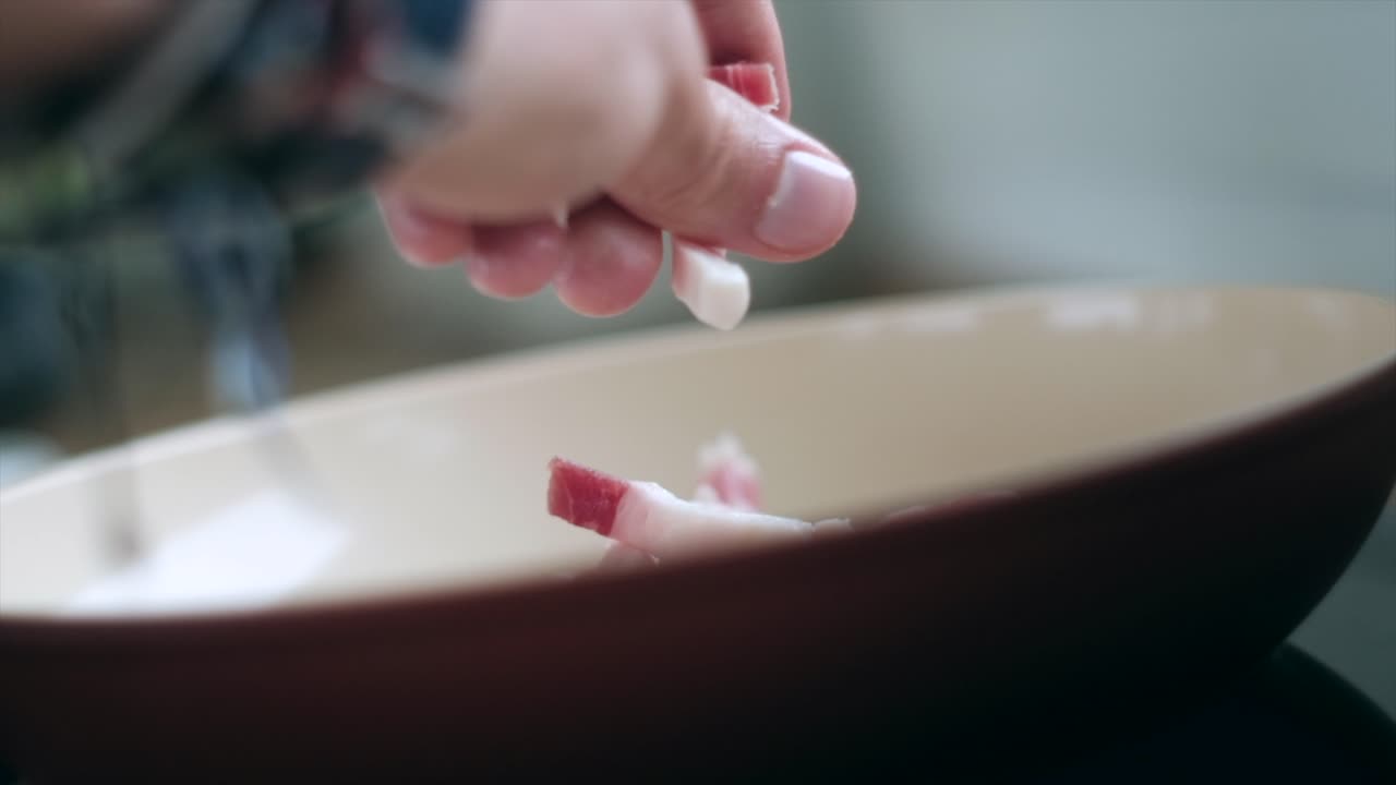 Artful Cooking: Beautiful Male Hand Adds Pancetta, Guanciale, and Bacon to Pan in Slow Motion for Carbonara