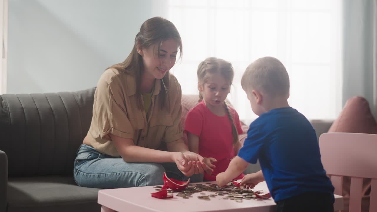 madre joven con hijos se regocijan en la alcancía rota