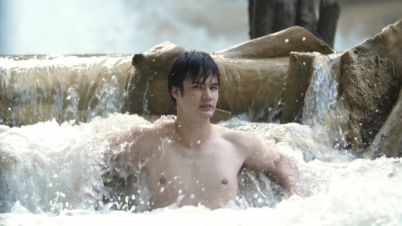 Man relaxing in a waterfall