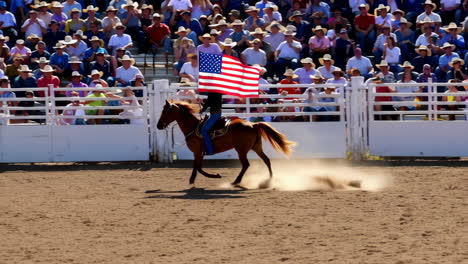 horseback rider with american flag at a rodeo