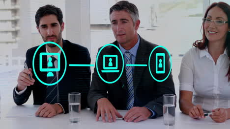 animation of network of connections with icons over caucasian colleagues at meeting