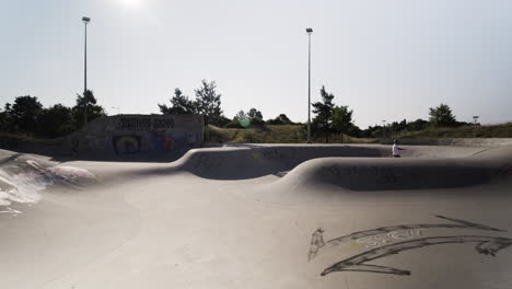 senior fitness and fun: elderly man riding a surf skate in a german skate park