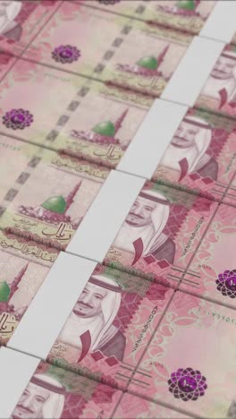 vertical video of 100 saudi riyal banknotes printing by a money press