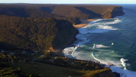 picturesque mountains full of lush green forest trees and pristine blue ocean of royal national park - aerial shot