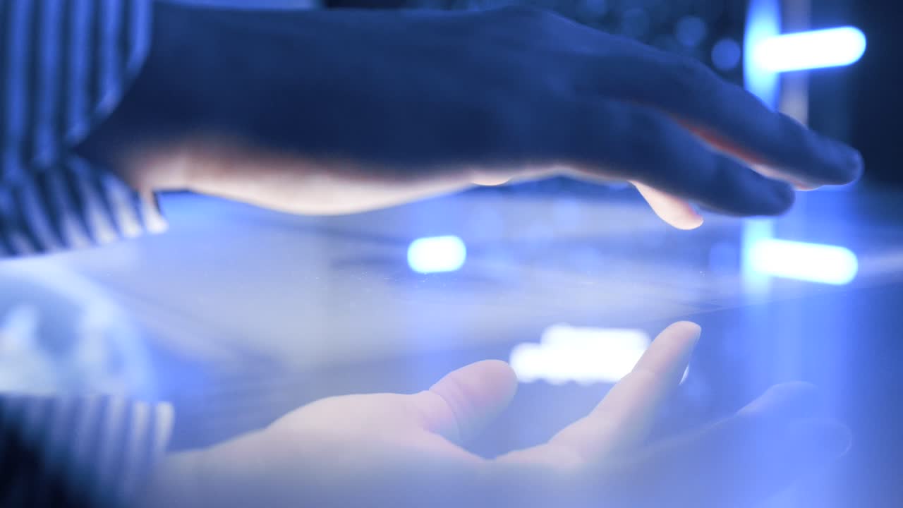 mesa iluminada e interactiva con pantalla táctil durante una mano de hombre que la utiliza en una vista de primer plano.