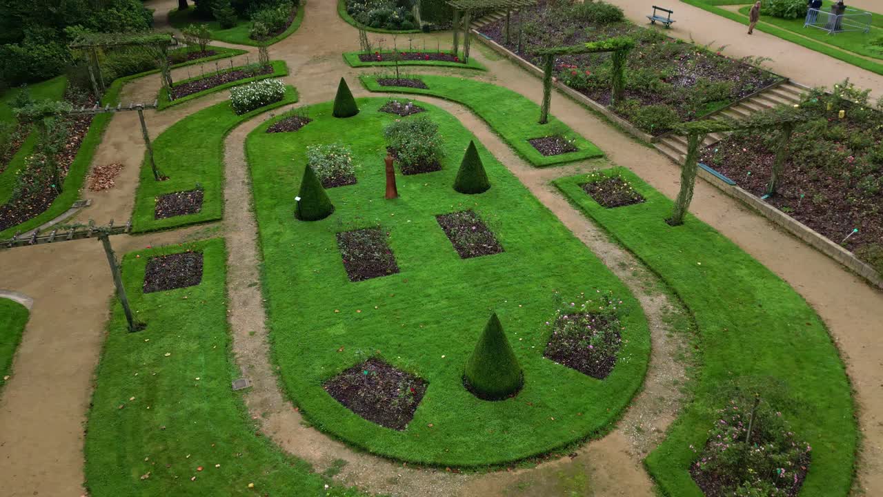 Beautiful Perrine botanical garden with pathways on upwards drone movement, Laval, France.