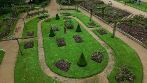 beautiful perrine botanical garden with pathways on upwards drone movement, laval, france.