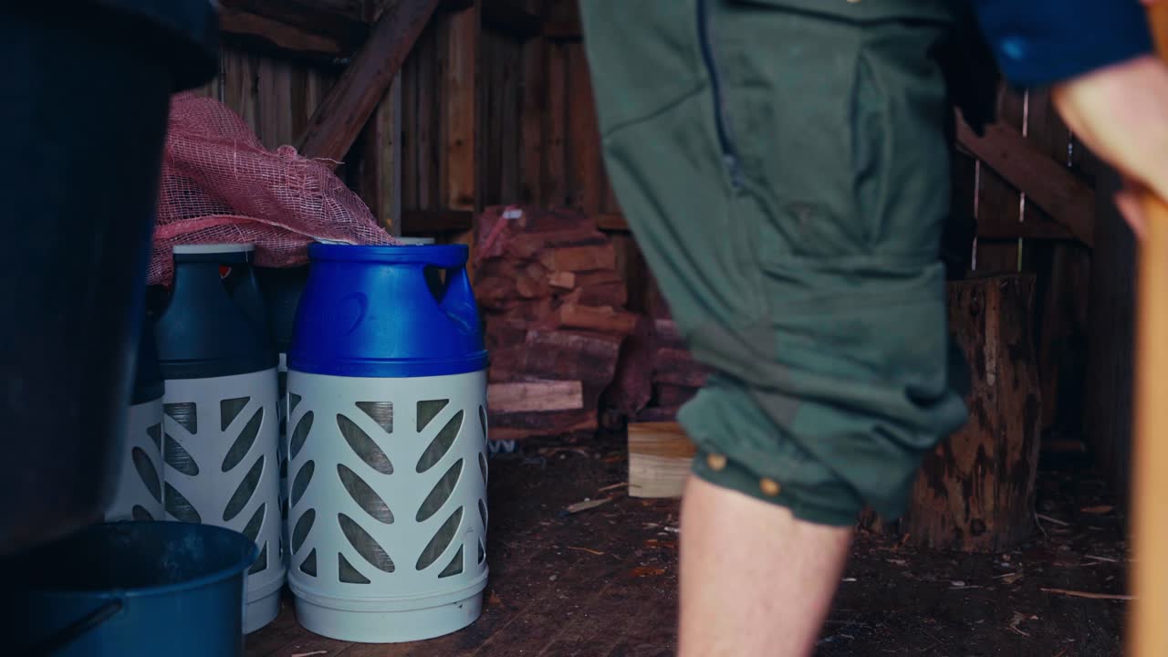 Person Cleaning Wooden Shed Using A Brush Broom. Close-up Shot