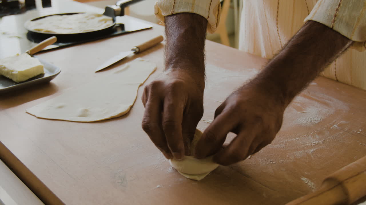 Man Preparing Flatbread in the Kitchen