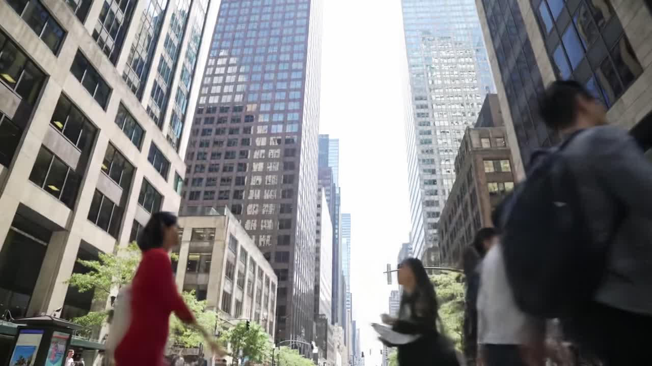 A bustling urban scene capturing the dynamic flow of pedestrians amidst towering skyscrapers, showcasing the vibrant energy of city life in a modern metropolitan area