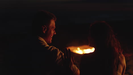 couple enjoying a campfire at night