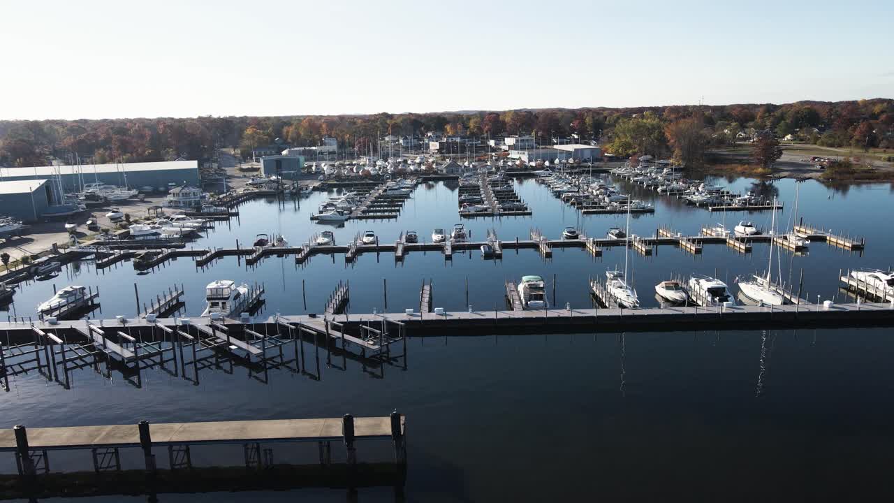 Sideways motion, tracking the calm water near a half empty Marina close to Winter