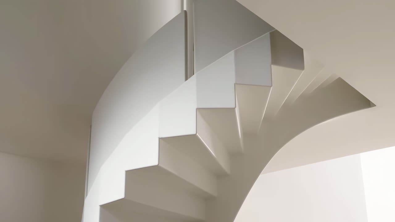 Upward Pan of a Modern White Spiral Staircase