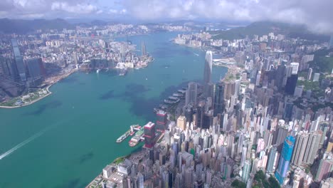 epic aerial view of the victoria harbour in a clear day, with thick cloud and sunlight