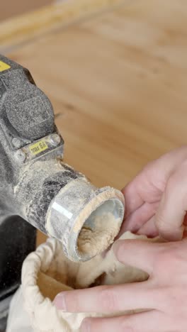 hands sanding wooden floor edges, creating smooth finishes with a handheld tool