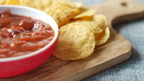 a bowl of chips and salsa on table