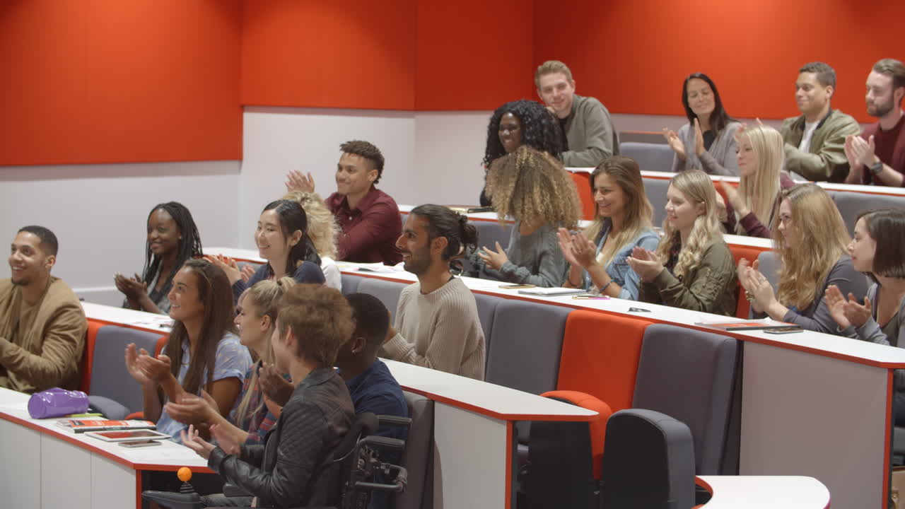 University students applauding at the end of a lecture