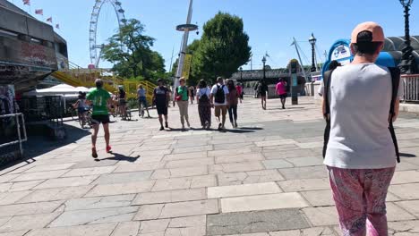 people walking along southbank centre, london