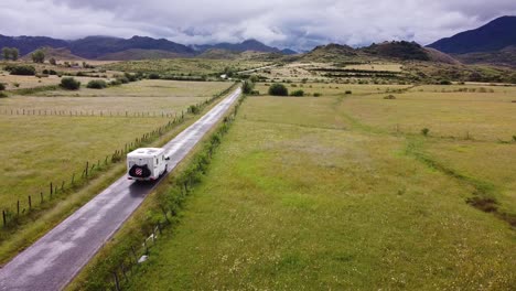 somiedo natural park - motorhome driving through the green valley and grassland at a cloudy day