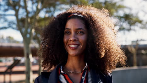 portrait of a smiling woman with curly hair