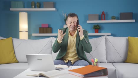 Home-office-worker-man-phone-angry-performs-business-call.