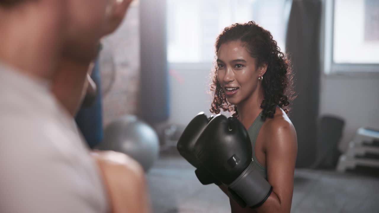 Woman training boxing with coach