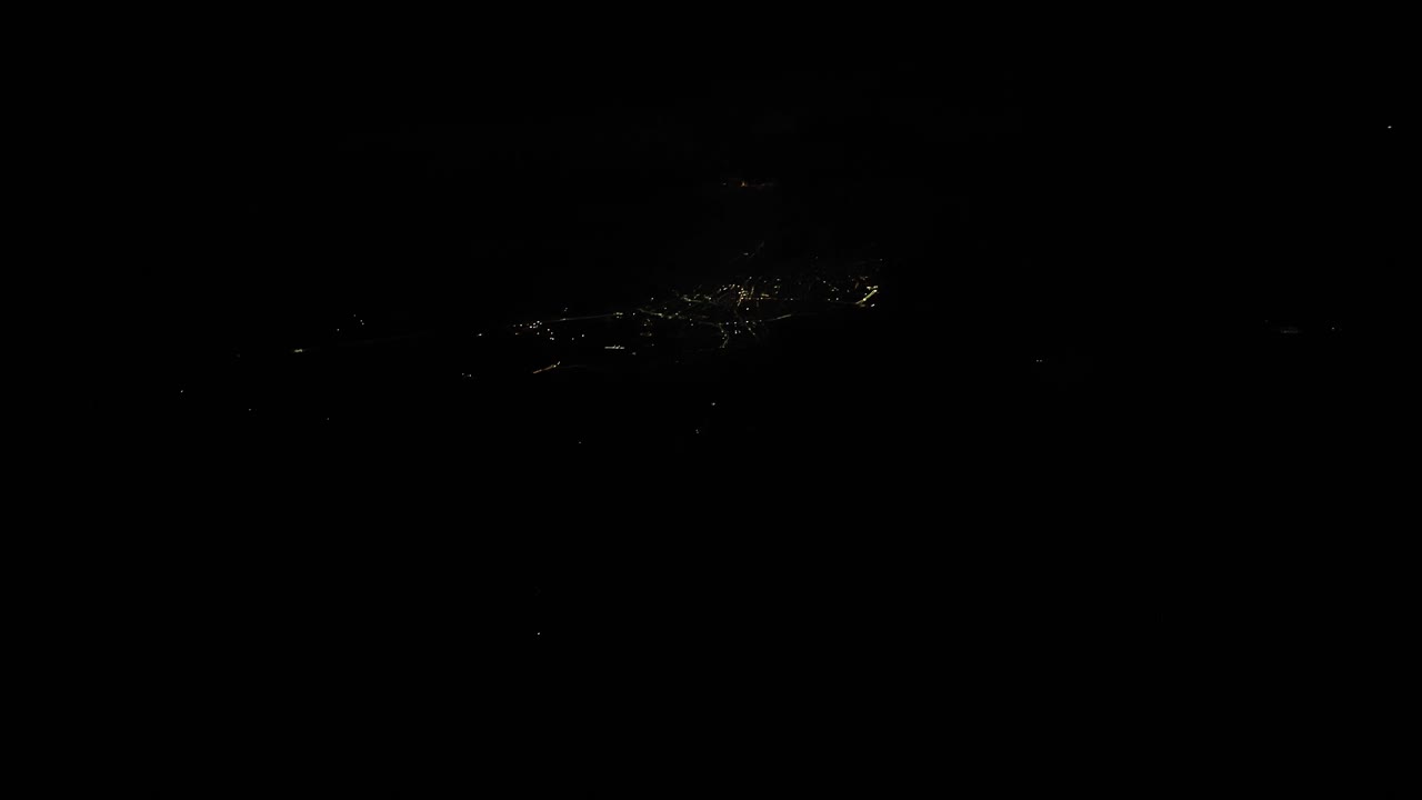 Plane view at night of city lights in the town over the Turkey.