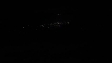 plane view at night of city lights in the town over the turkey.