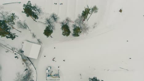 aerial-motion-over-ski-resort-with-people-sliding-on-trails