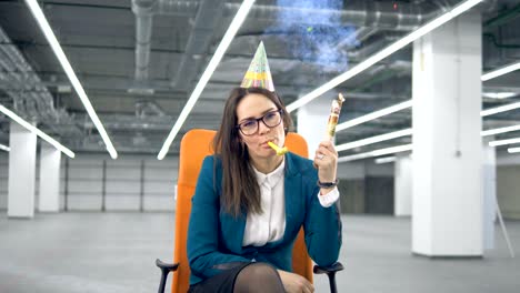 exhausted female employee is blowing a cracker