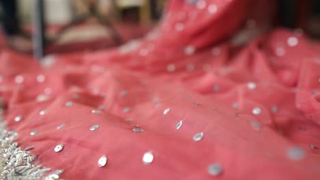 detail of bottom half of pink peach lehenga laid out on floor