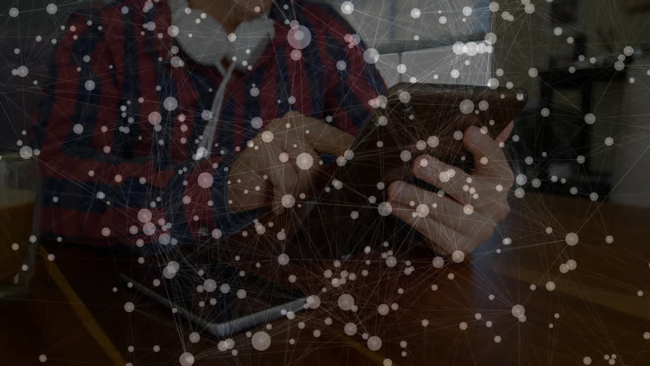 man tapping tablet in home office, displaying semi?transparent network graph overlay for technology
