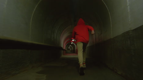 parkour athlete running in tunnel and doing front flip