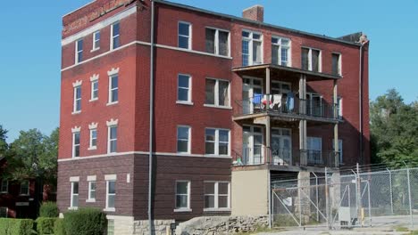 Wide-shot-of-laundry-blowing-on-the-back-porch-of-a-tenement-in-the-inner-city