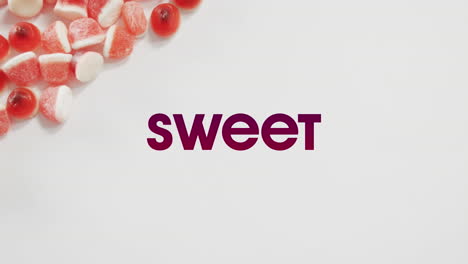 animation of halloween sweet text over sweets on grey background