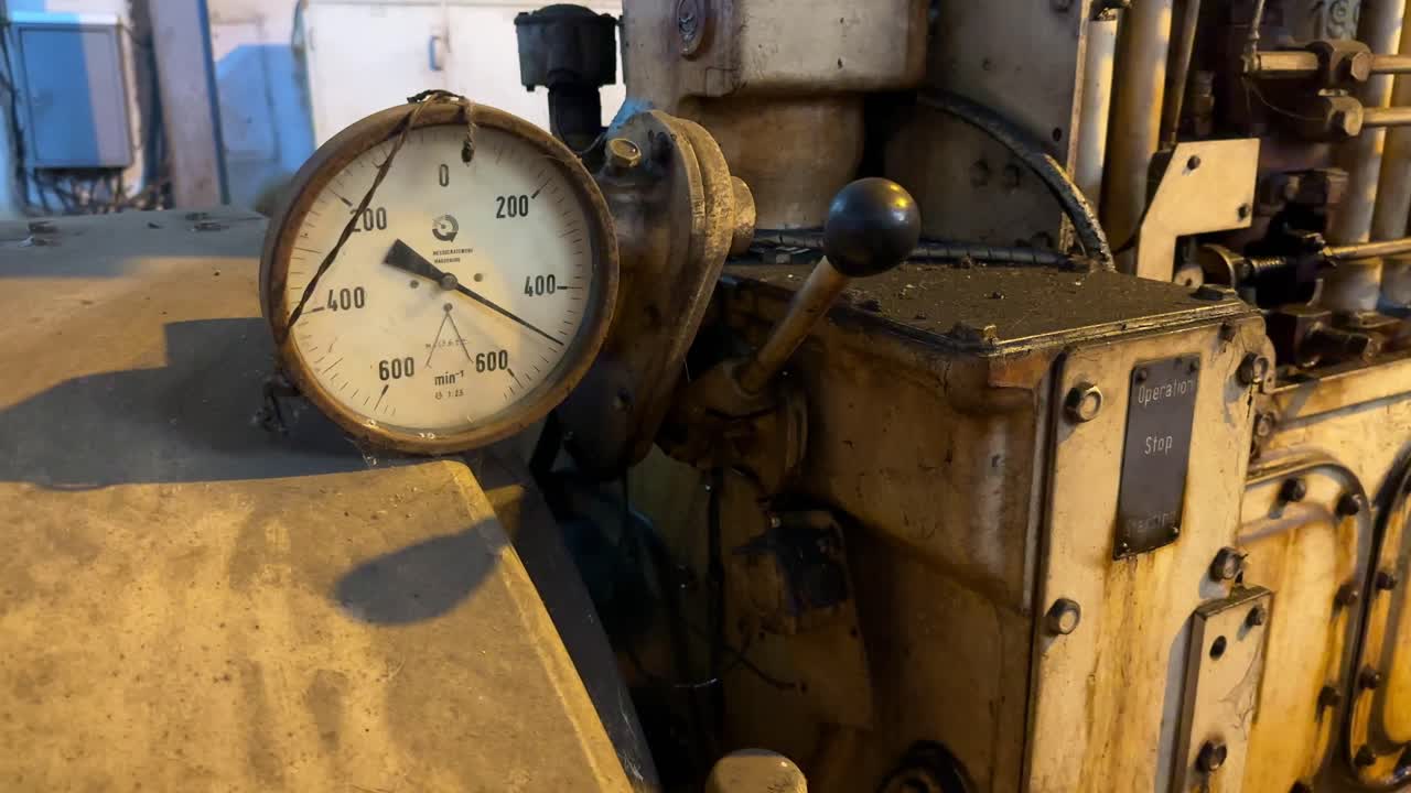 An old dirty pressure gauge mounted on an old generator machine