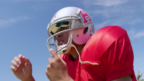 American-football-player-standing-with-helmet