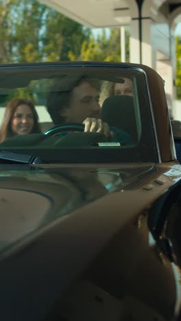 couple enjoying a drive at a gas station