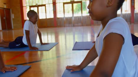 schoolkids performing yoga on a exercise mat in school 4k