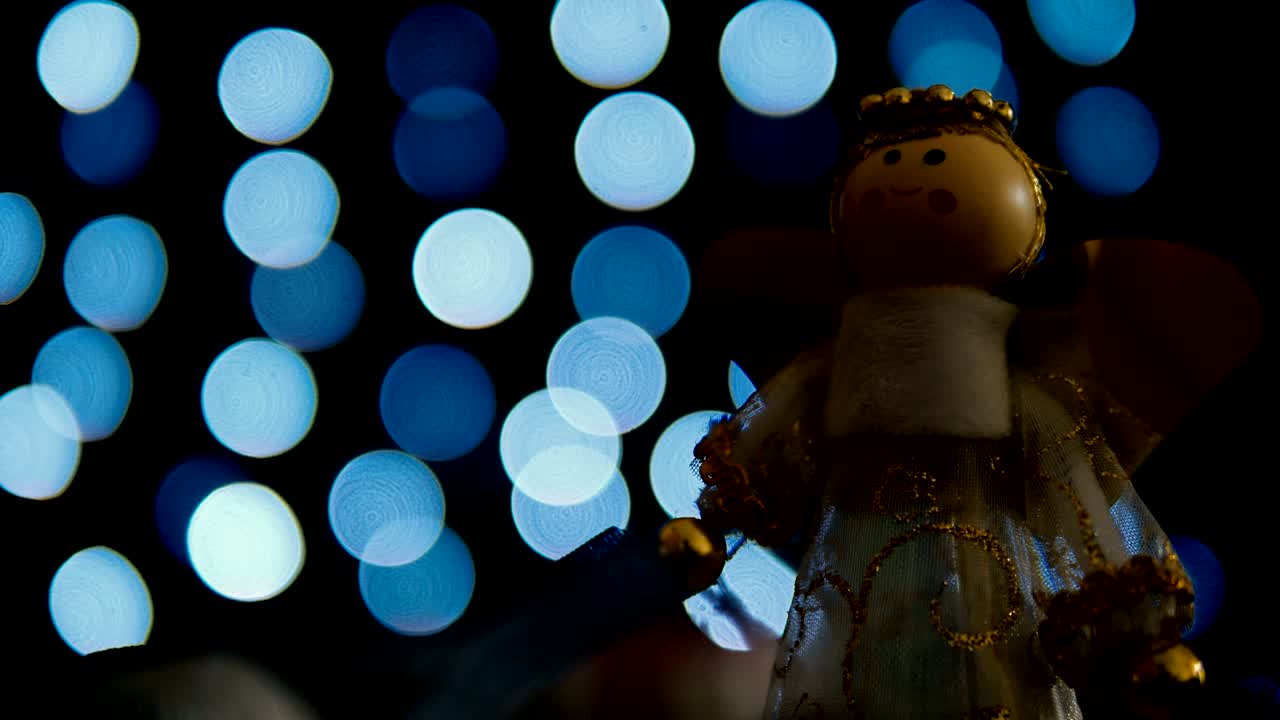 Angle Christmas decoration with blue bokeh lights loop