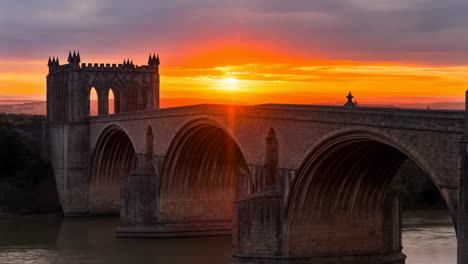 historic stone arch bridge at sunset