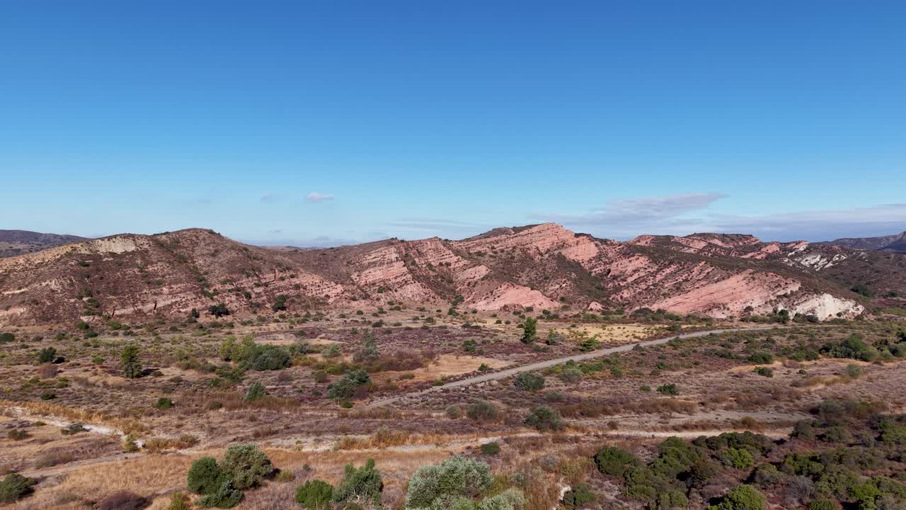 Drone footage shows rolling hills and brushy terrain under a clear sky in Black Star Canyon Wilderness