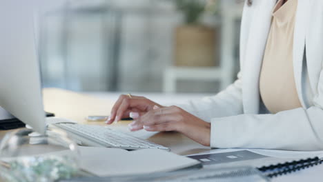 female hands typing an email on her computer