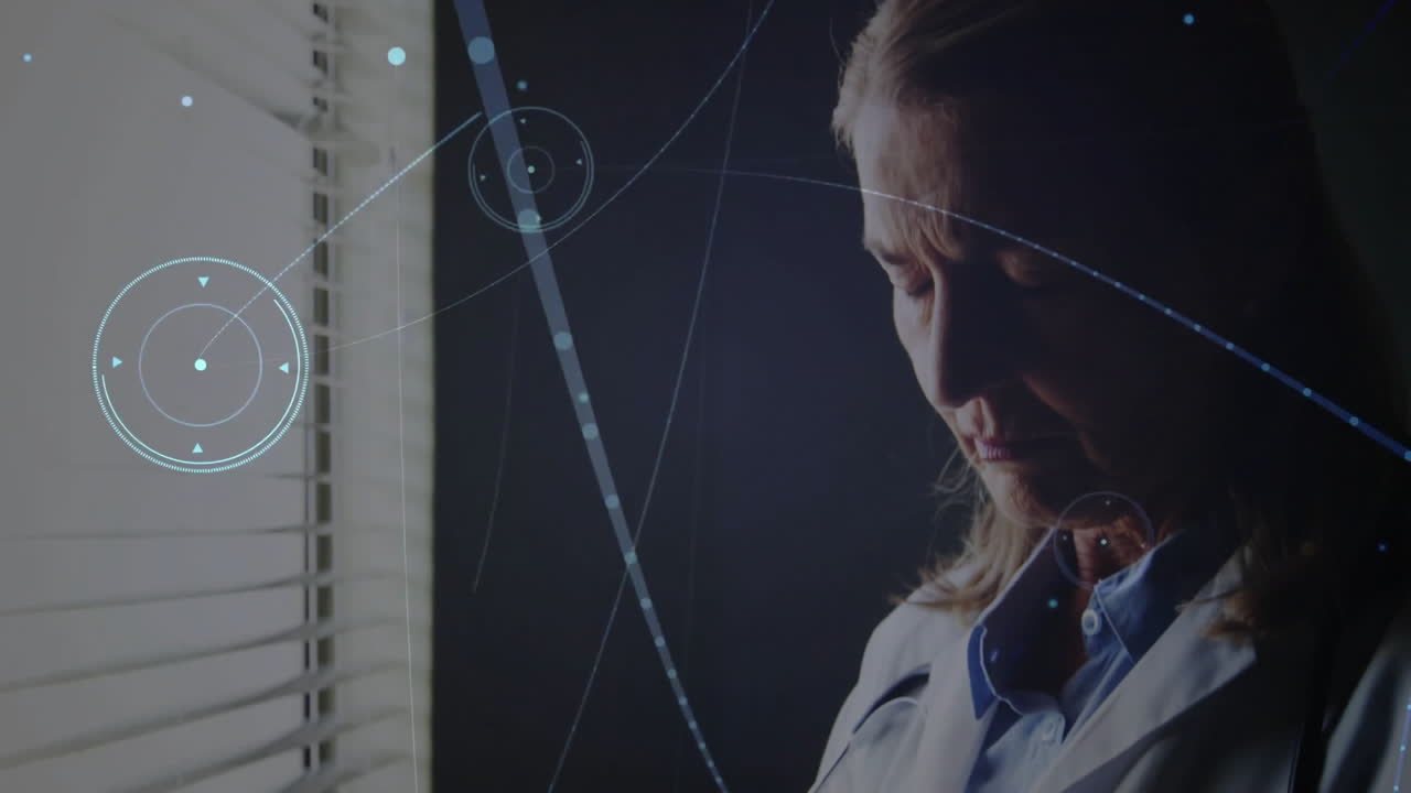 Senior woman standing gazing through blinds, overlaying HUD graphics and tech data lines