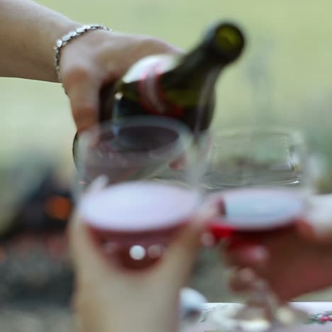 pouring red wine into the glasses
